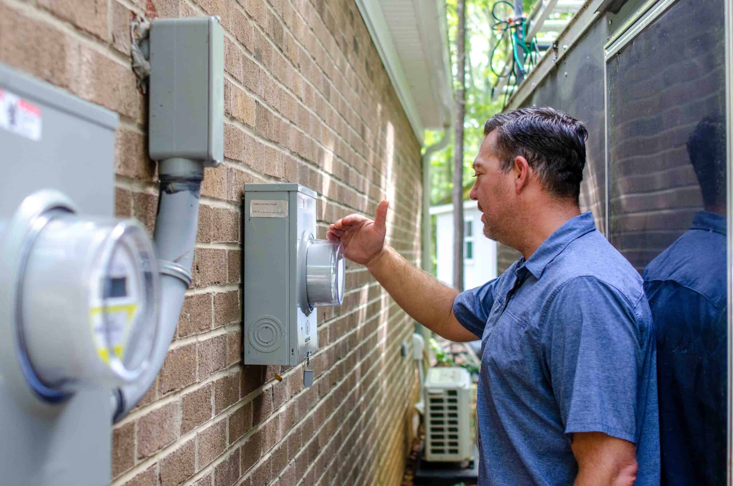 YEC's Brent Clinton looking at an electricity meter