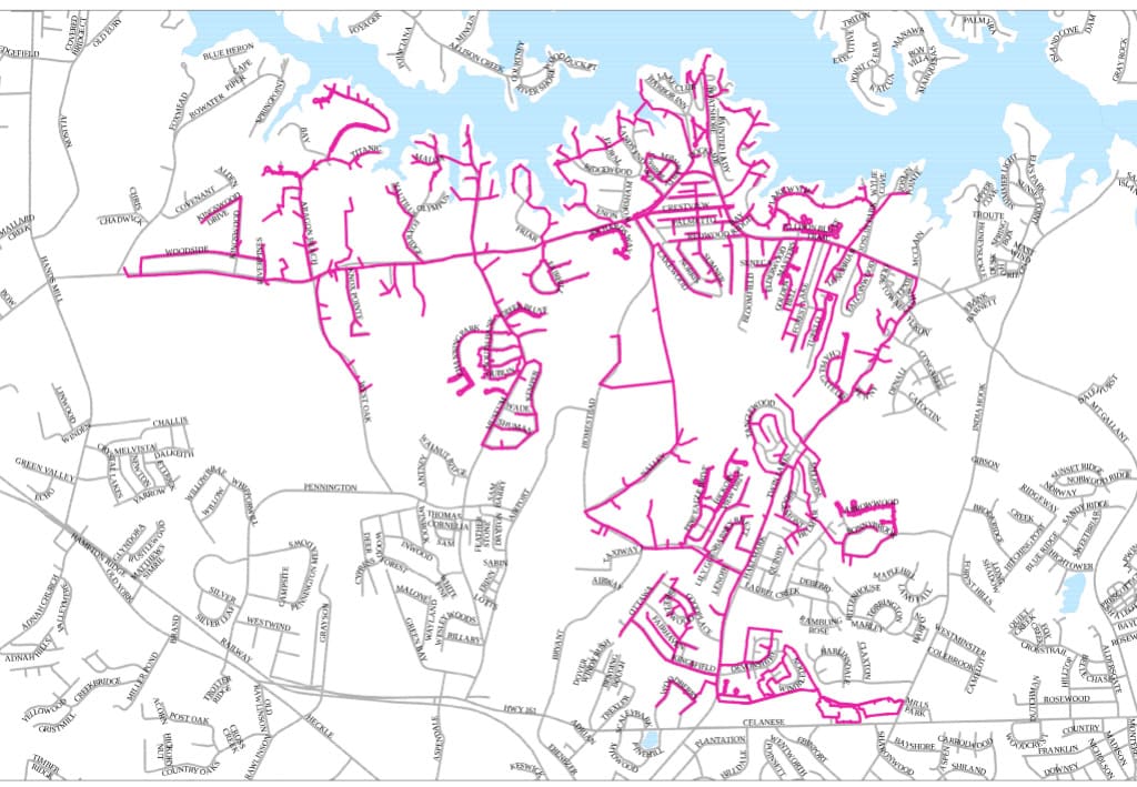 Map highlighting specific roads in pink around a lakeside area, showing detailed street names and neighborhood layouts with surrounding water bodies.