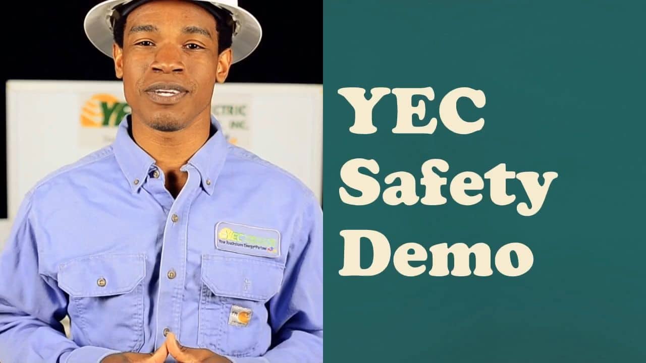 A person in a blue shirt and white helmet stands beside text reading "YEC Safety Demo," with a background logo partially visible.