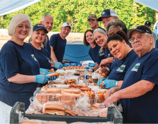 Snapshot of volunteers serving up free hot dogs