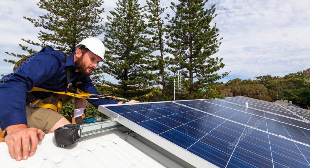 Technician installing rooftop solar