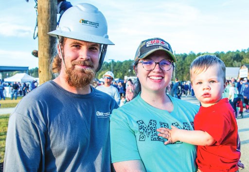 A lineman poses with his family