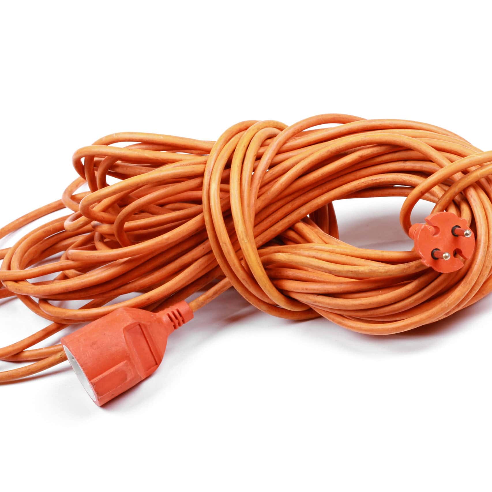 This image shows a coiled orange extension cord with a three-prong plug, isolated on a white background.