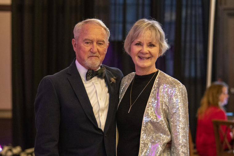 A well-dressed couple arrive at the event.