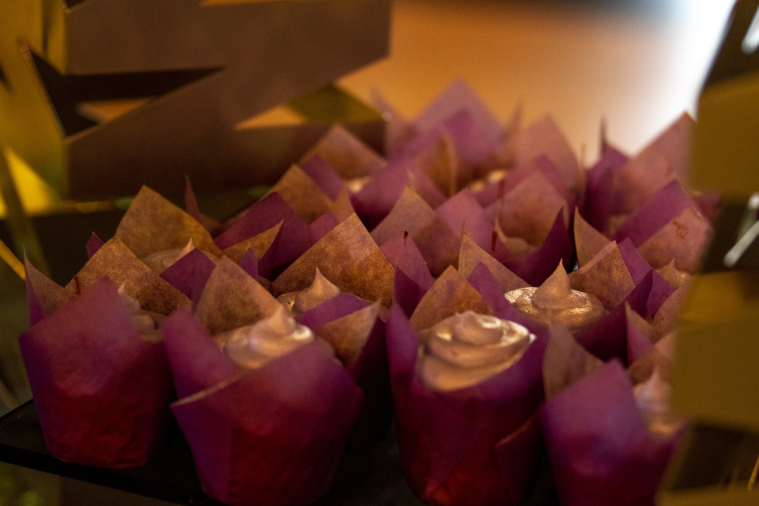 Beautifully decorated cupcakes are set up to tempt guests.