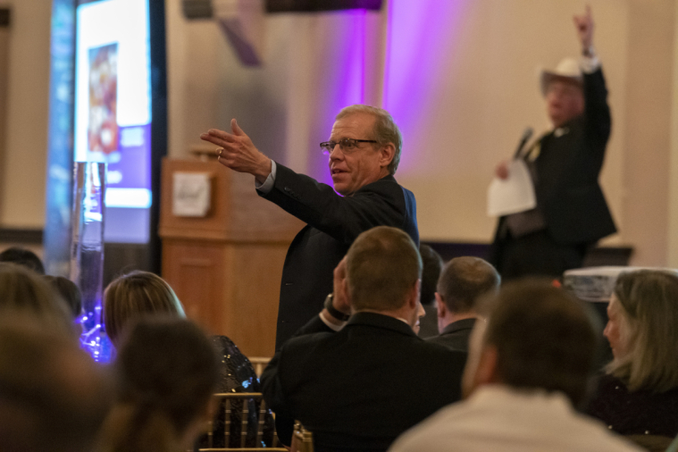 The two auctioneers work in tandem to find the winner.