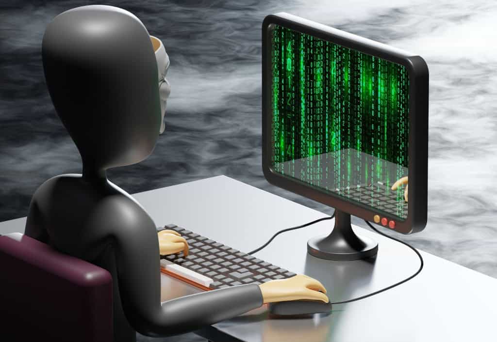 A person sitting at a desk using a computer with green digital code on the screen, reminiscent of a hacking scenario.