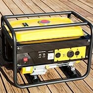 A yellow portable generator with a metal frame is placed on a wooden deck outdoors, displaying various electrical outlets and controls.